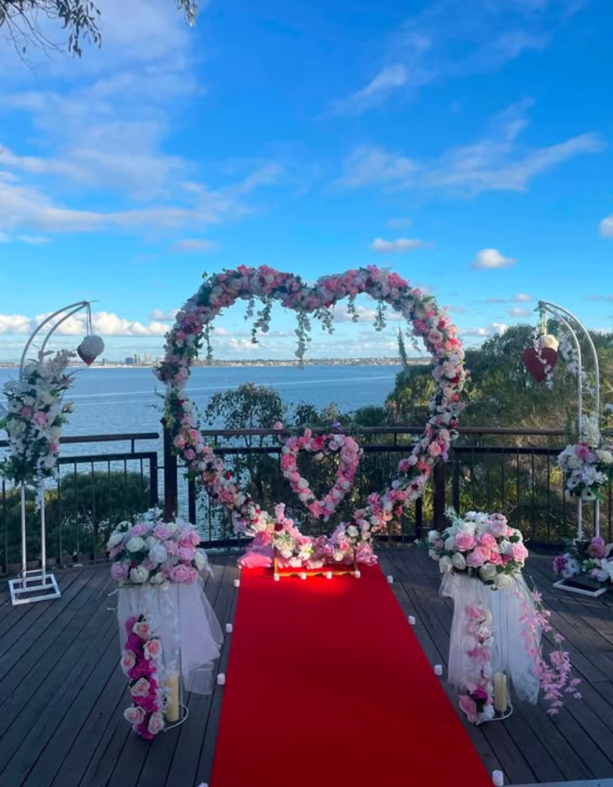 Daytime riverside floral arch