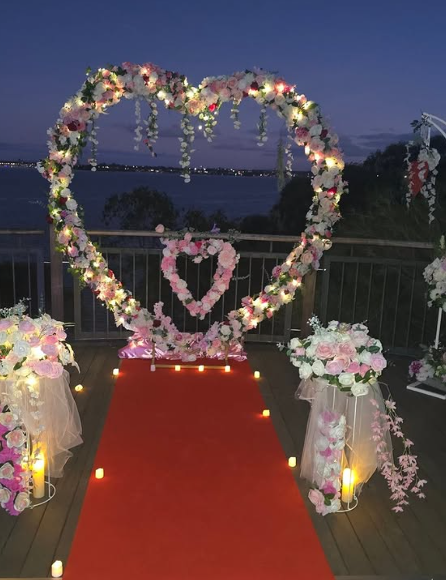 Twilight proposal — fairy lights and a candle-lit aisle.