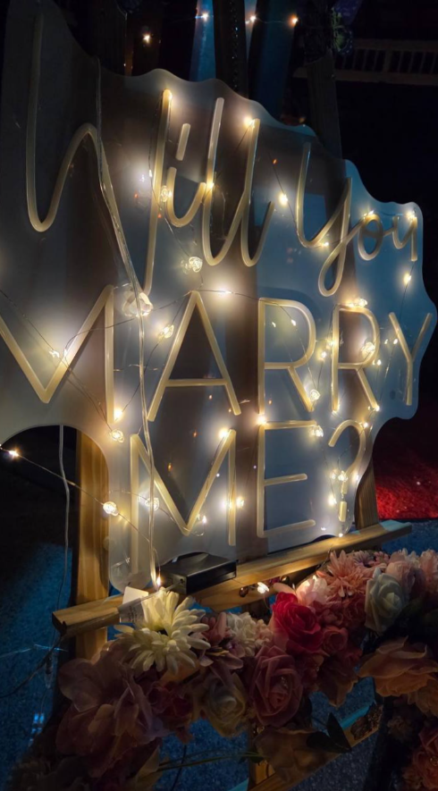 Custom proposal signage, hand-wrapped in fairy lights.